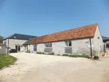 A detached four bedroom barn conversion with a good sized rear garden, workshop/garage, barns and paddock located in the